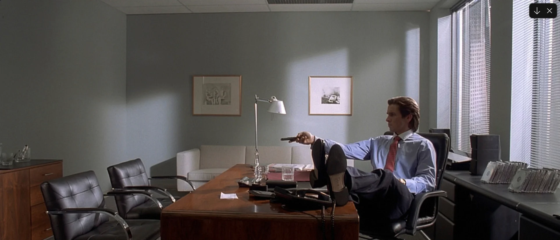Office scene still from American Psycho used as a cinematic reference image.
